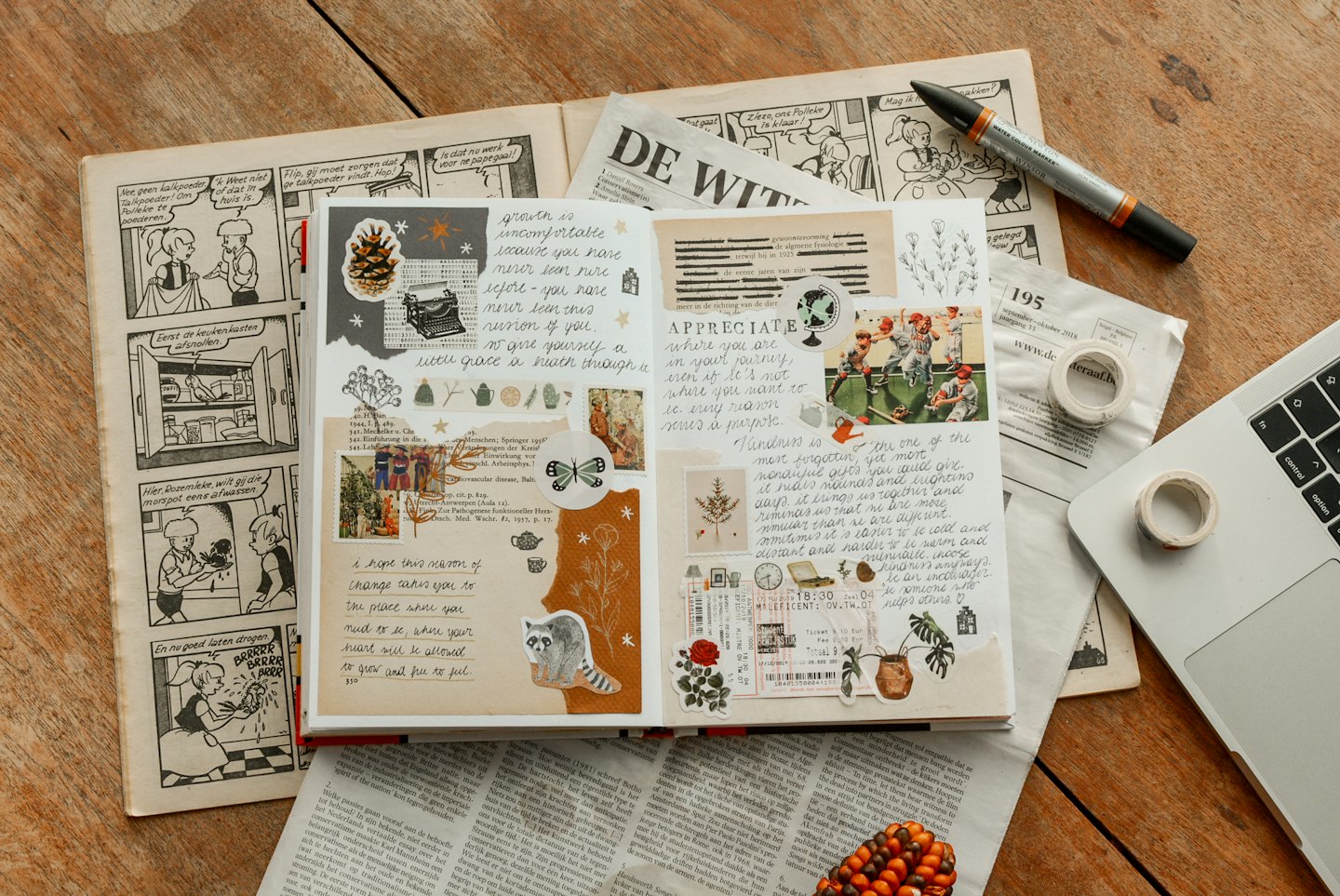 Creative journal open on a rustic wooden table with craft supplies.