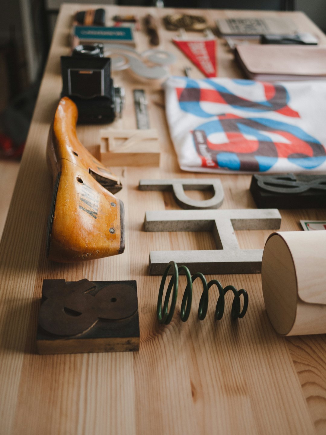 Vintage camera and craft tools on a wooden table.